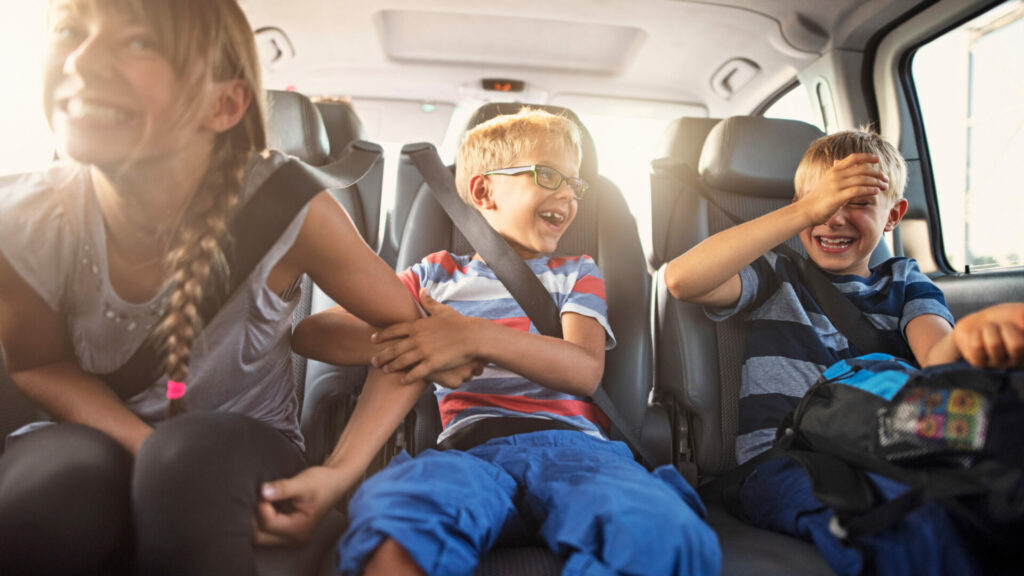 subaru forester features - kids in the back seat with safety belts on